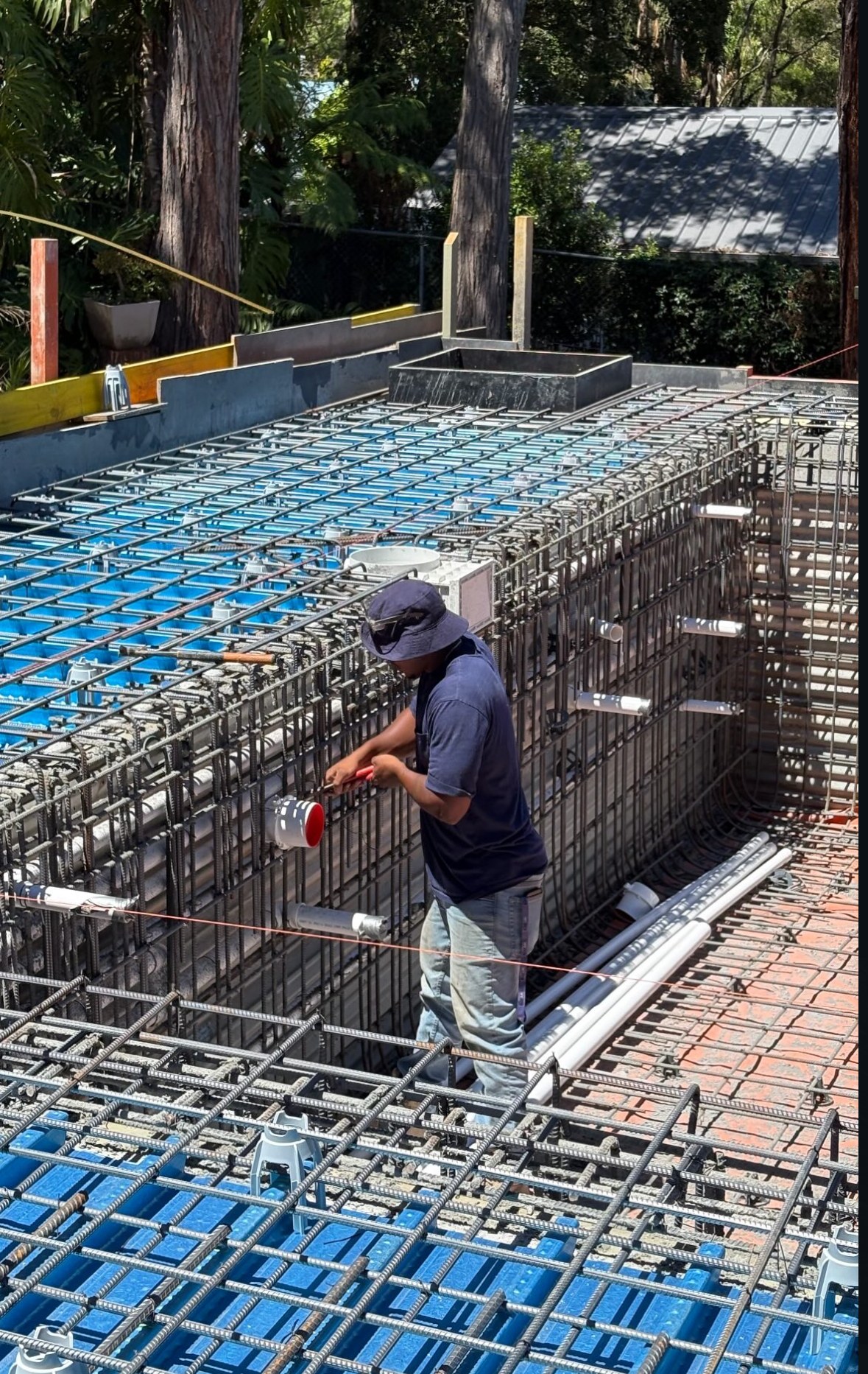 A steel fixer working among reinforcement on a Sydney site